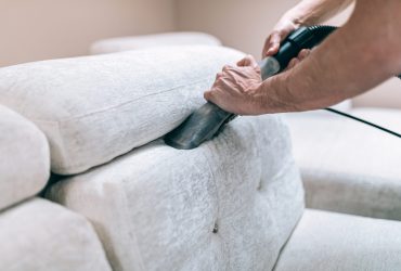 Process of deep furniture cleaning, removing dirt from sofa. Washing concept.